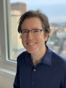 Photograph of composer David McMullin, facing viewer, smiling